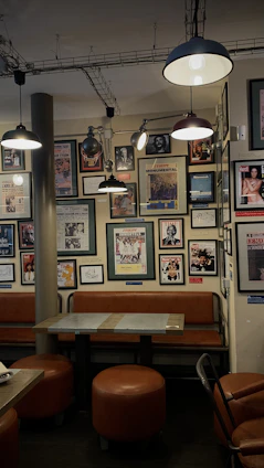 A cozy retro cafe corner with vintage Turkish posters and classic 80s decor.