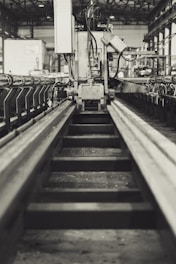 A realistic industrial banner featuring a machine in orange color on the right, with a clean, modern warehouse background.