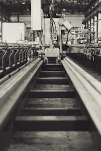 Minimalist photo of a modern factory floor with precise machinery in monochrome.