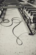 Close-up image of a thick, green industrial cable coiled neatly in a factory setting