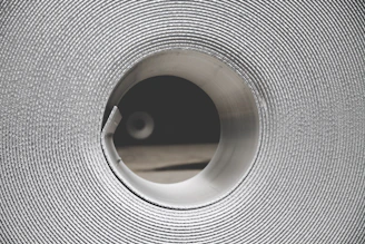 Close-up of smooth white PA6 nylon roll material under soft lighting