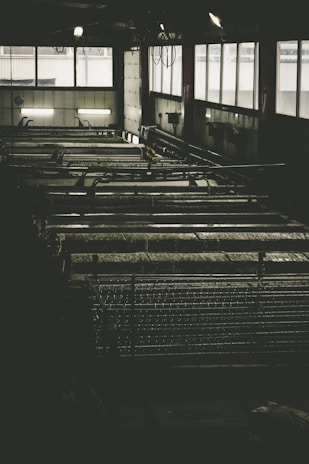 Industrial equipment with matte black finish and subtle grey details under soft lighting.