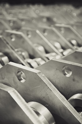 Abstract macro view of interlocking dark metal plates with subtle reflections.