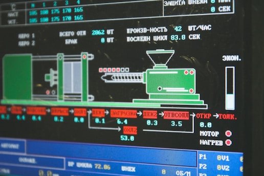 A computer screen displaying a graphical interface with technical information, possibly related to manufacturing or machinery operation. The interface includes a diagram of an industrial machine, text in Cyrillic script, and various numerical data.