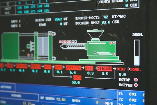 A computer screen displaying a graphical interface with technical information, possibly related to manufacturing or machinery operation. The interface includes a diagram of an industrial machine, text in Cyrillic script, and various numerical data.