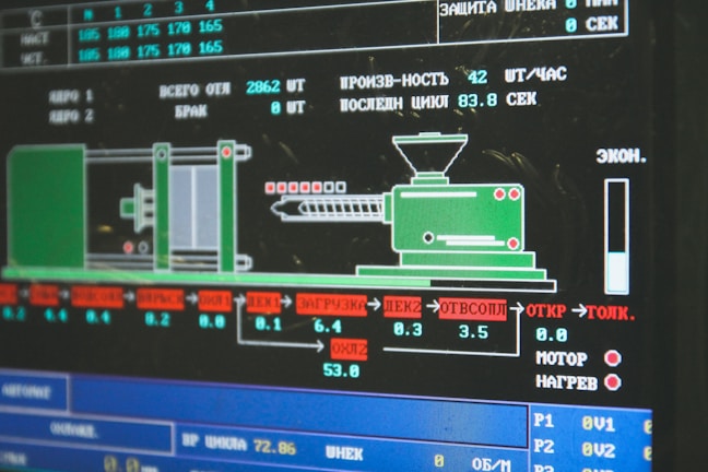 A computer screen displaying a graphical interface with technical information, possibly related to manufacturing or machinery operation. The interface includes a diagram of an industrial machine, text in Cyrillic script, and various numerical data.