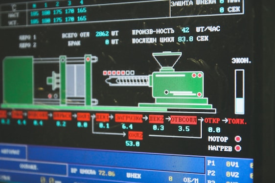 A computer screen displaying a graphical interface with technical information, possibly related to manufacturing or machinery operation. The interface includes a diagram of an industrial machine, text in Cyrillic script, and various numerical data.