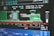 A computer screen displaying a graphical interface with technical information, possibly related to manufacturing or machinery operation. The interface includes a diagram of an industrial machine, text in Cyrillic script, and various numerical data.