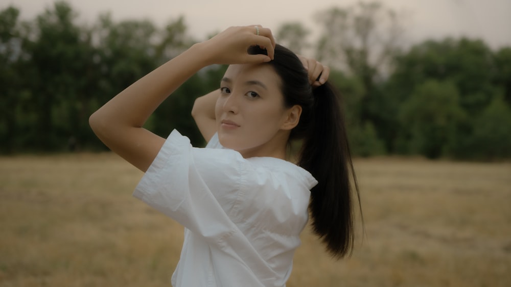 a woman with her hair in a ponytail