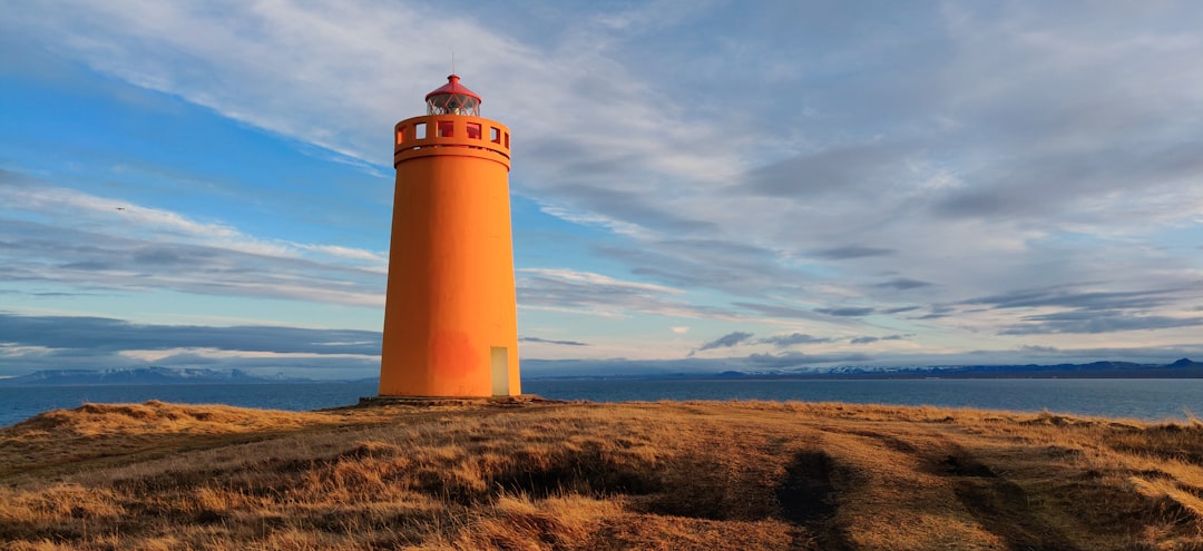 a lighthouse on a hill, Holmsberg Lighthouse, Keflavik @tundekilinphotography