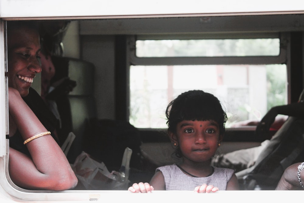 a person and a child sitting in a car