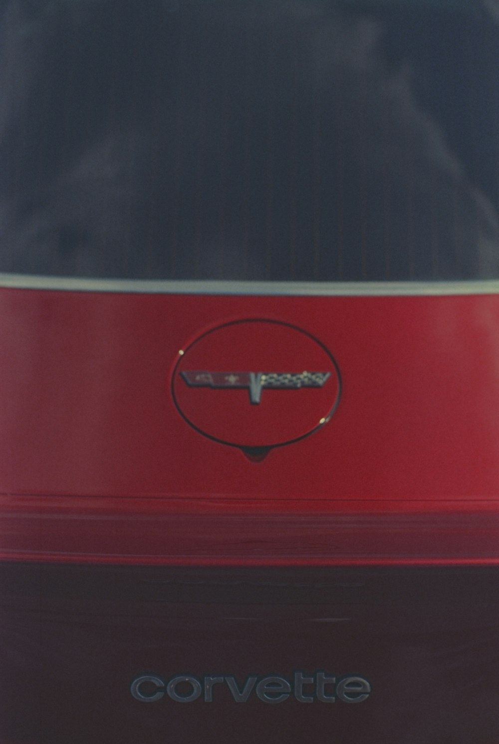 a red rectangular object with a black circle on it