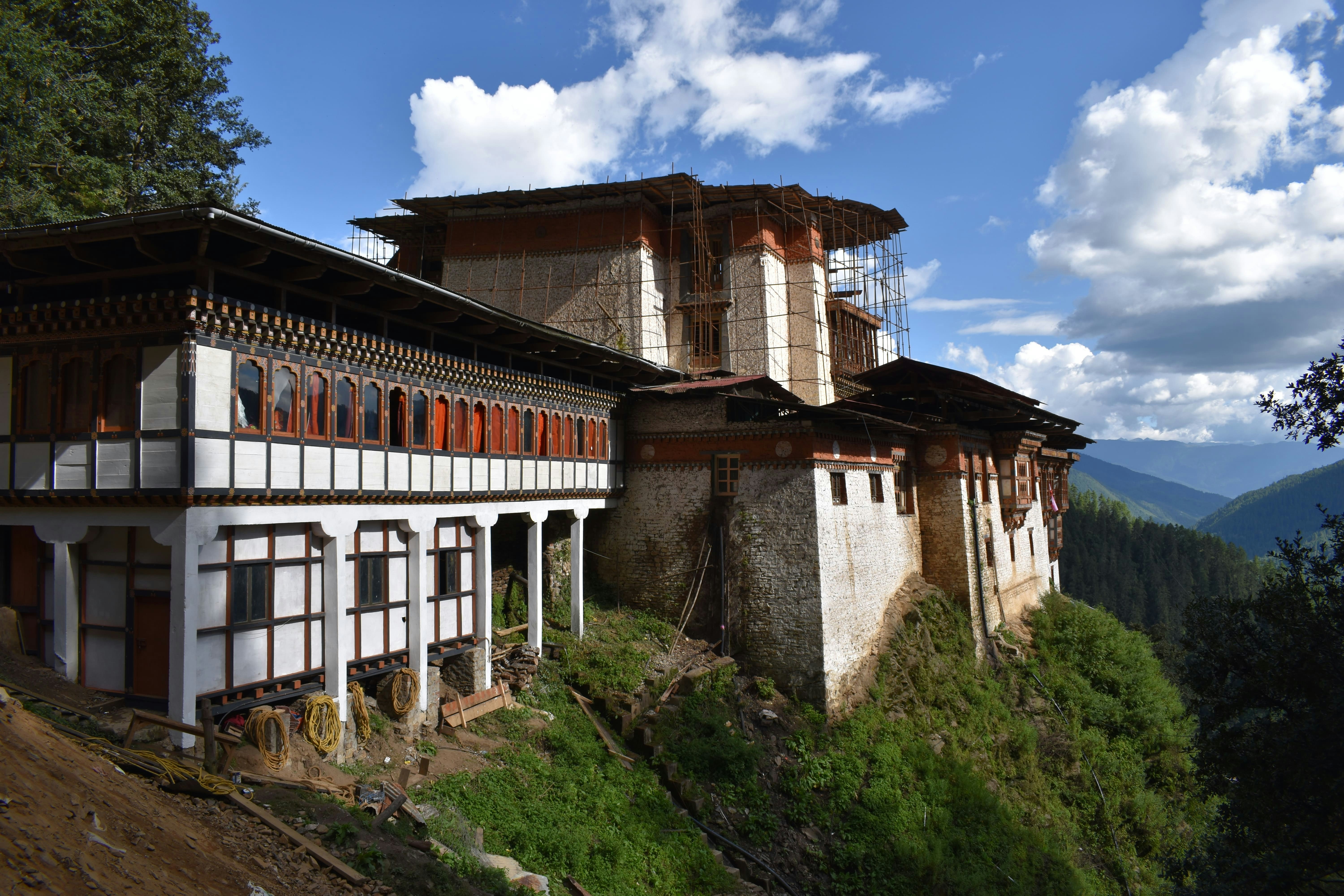 a building on a hill, Tango and Cheri monasteries are placed on steep hills facing one another and are located in the Northern valley of Thimphu. Find more here: https://trulybhutan.com/attractions-in-thimphu/tango-and-cheri-monasteries