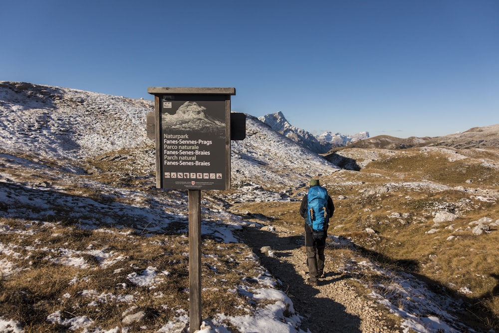 a person standing next to a sign