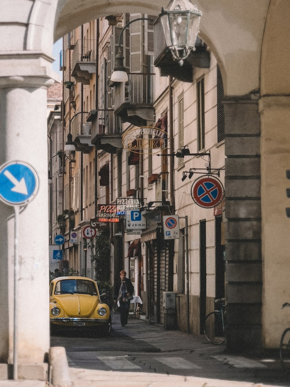 a yellow car parked on the side of a street