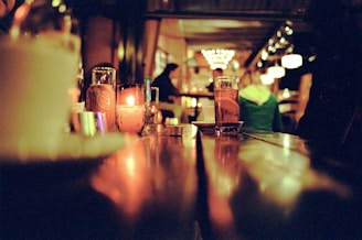 a bar with a few glasses of liquid on the table