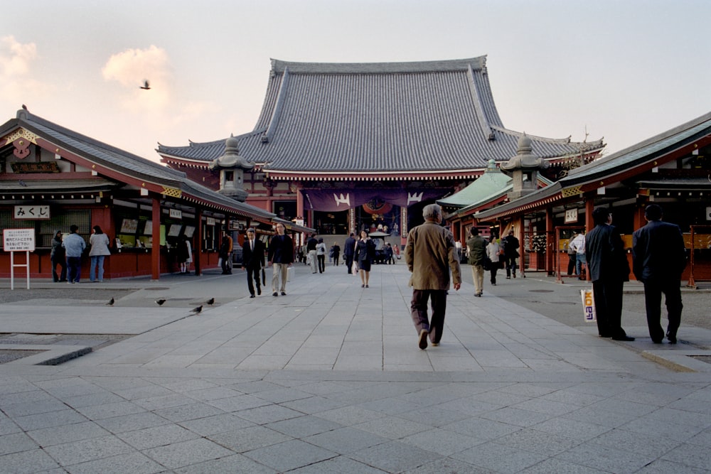 a group of people walking around Sensō-ji