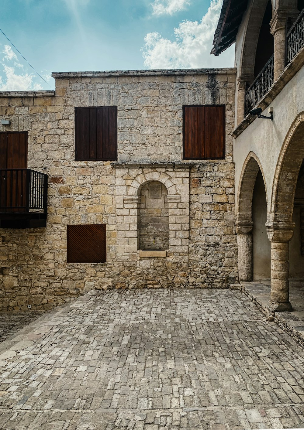 a stone building with a brick walkway