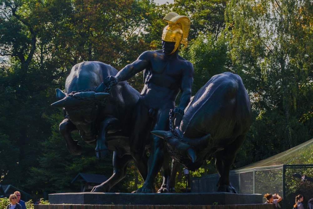 a statue of a man riding a bull