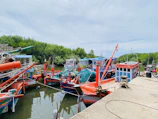Colorful fishing boats docked near a vibrant coral reef in crystal-clear water