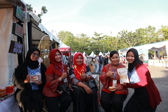 A group of women participating in a community cultural event outdoors.
