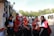 A group of women in traditional attire smiling together at a community event.