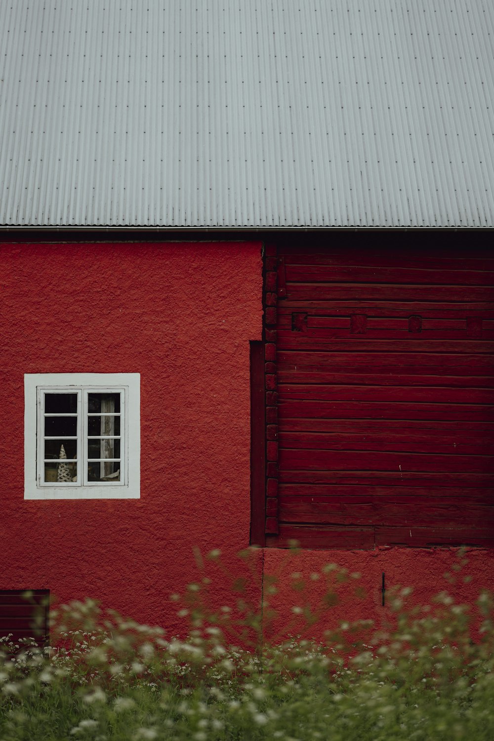 a red barn with a white window
