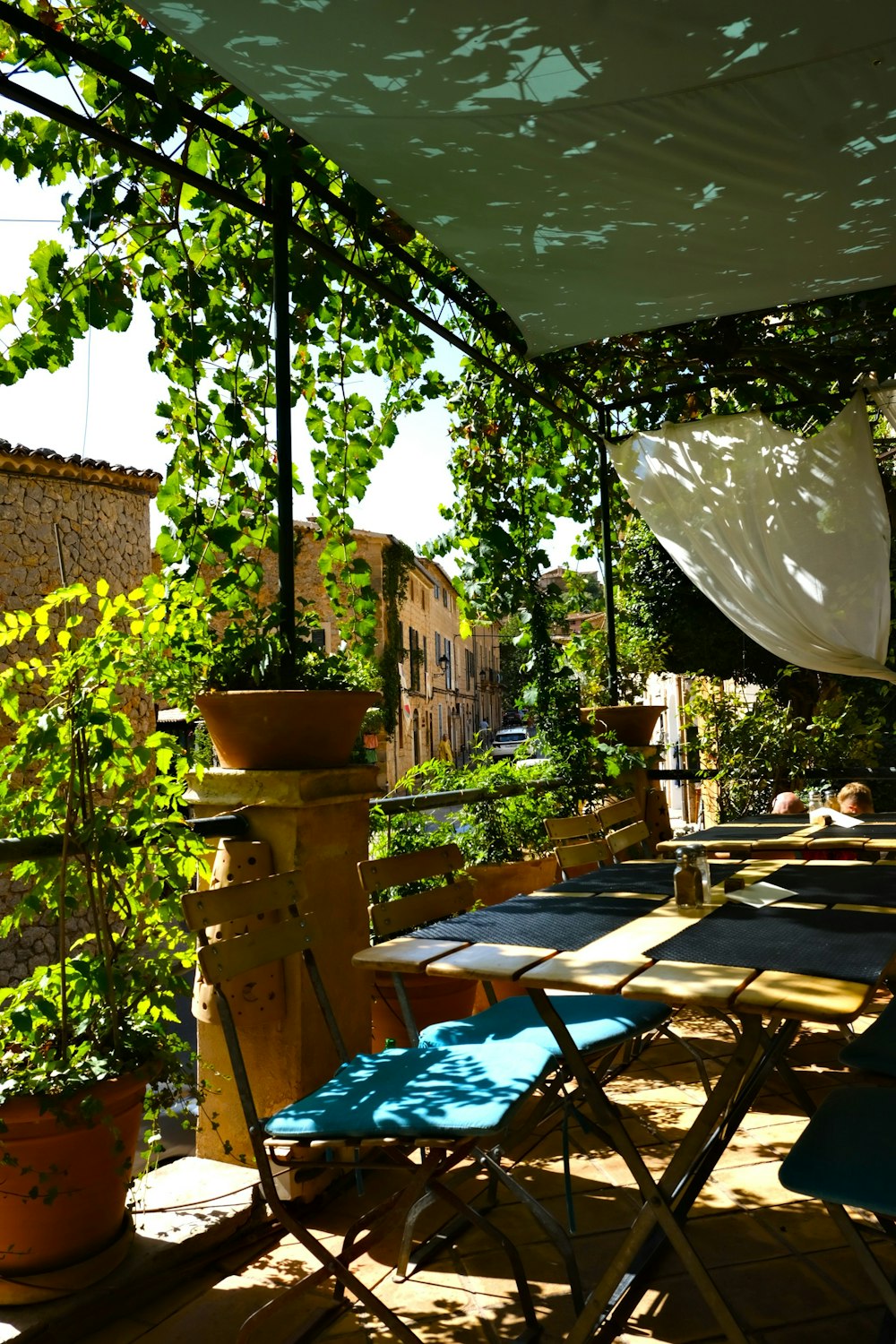 a table and chairs under a green tent