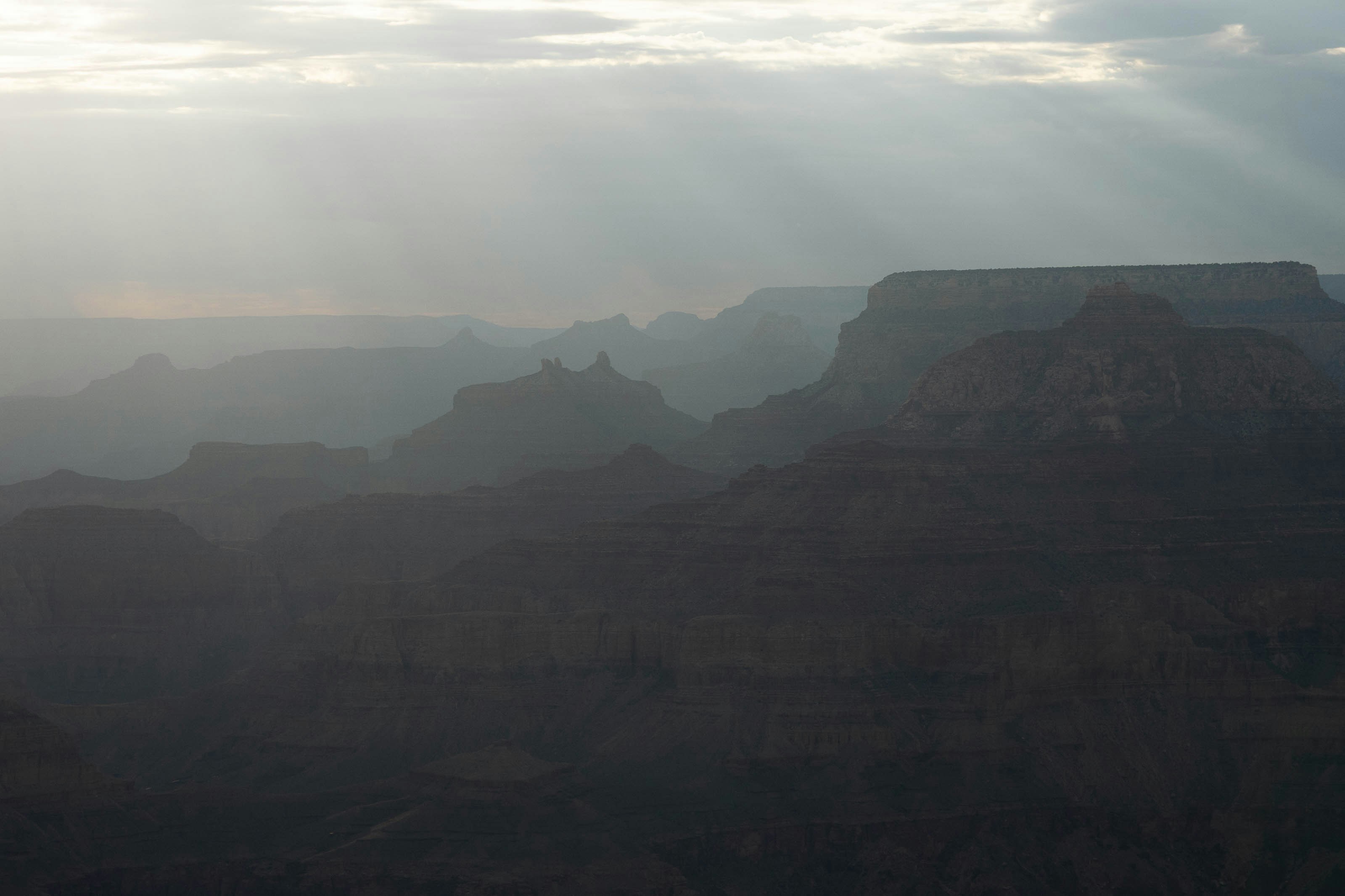 a landscape with hills and fog