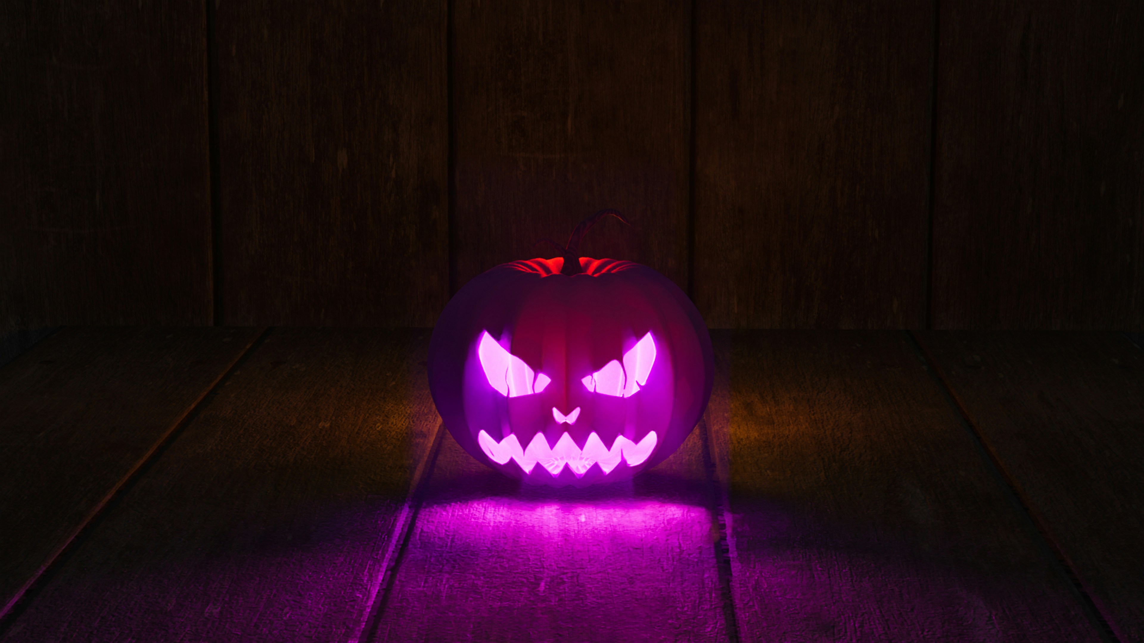 A carved pumpkin on a wood