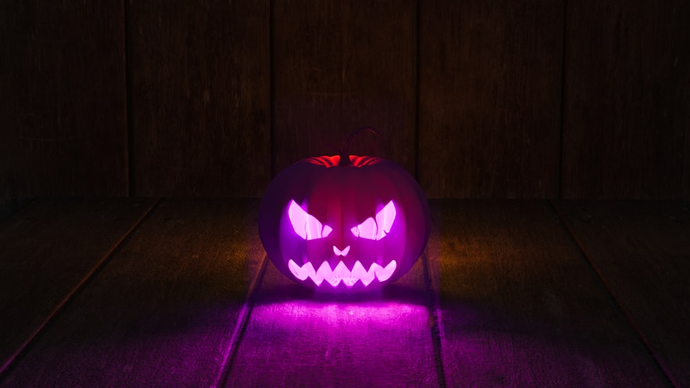 a carved pumpkin on a wood floor