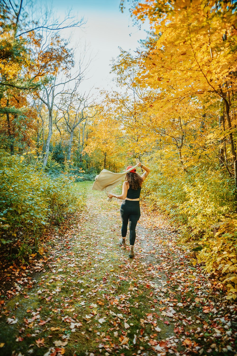 a person walking down a path with an umbrella