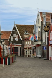 a brick road with buildings on either side of it