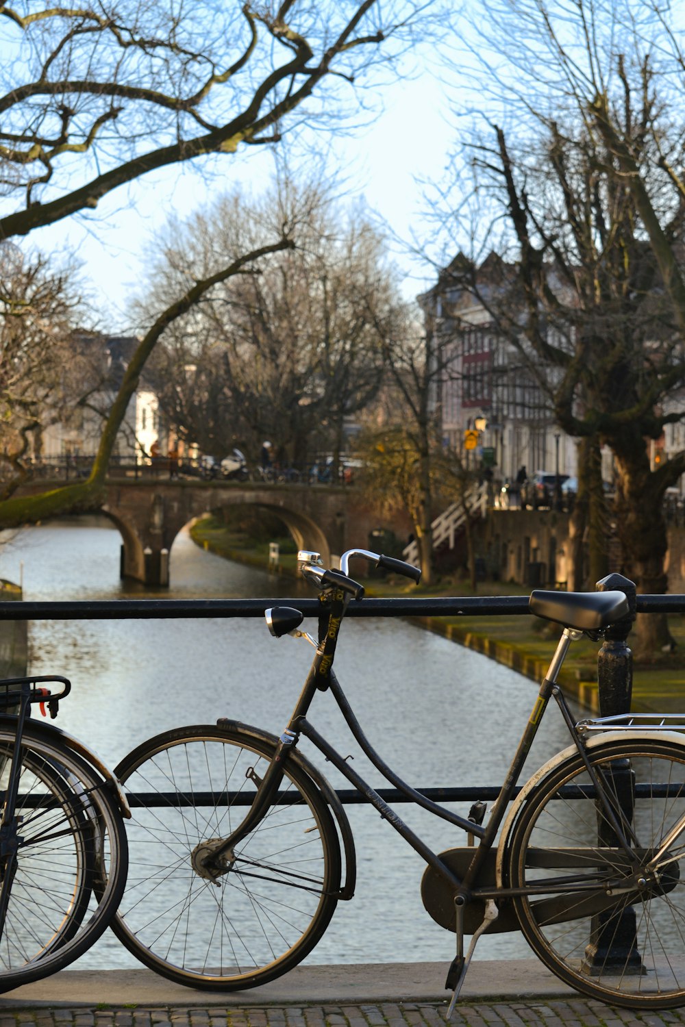 a group of bicycles parked on a bridge over a river