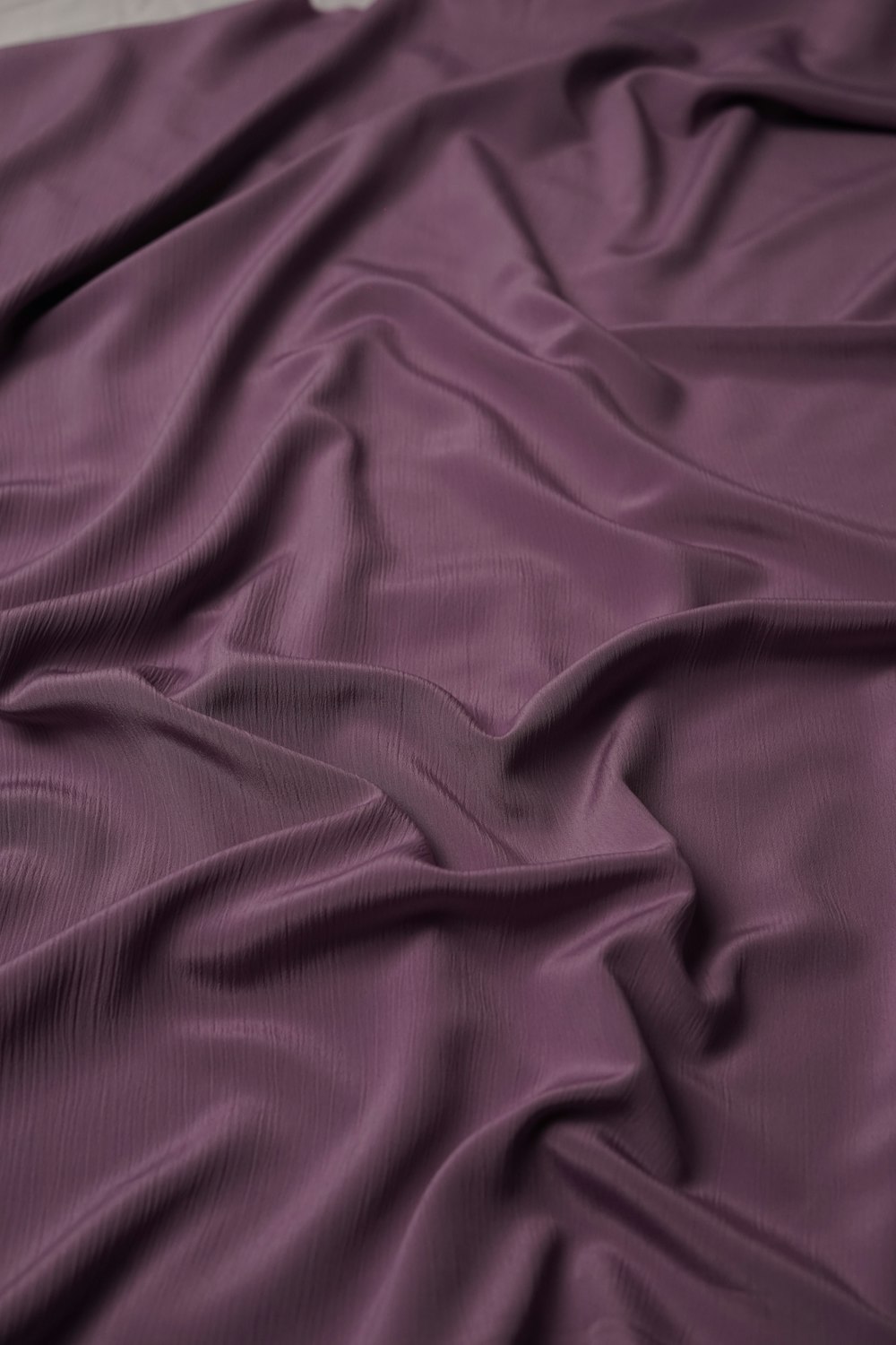 a purple blanket on a bed