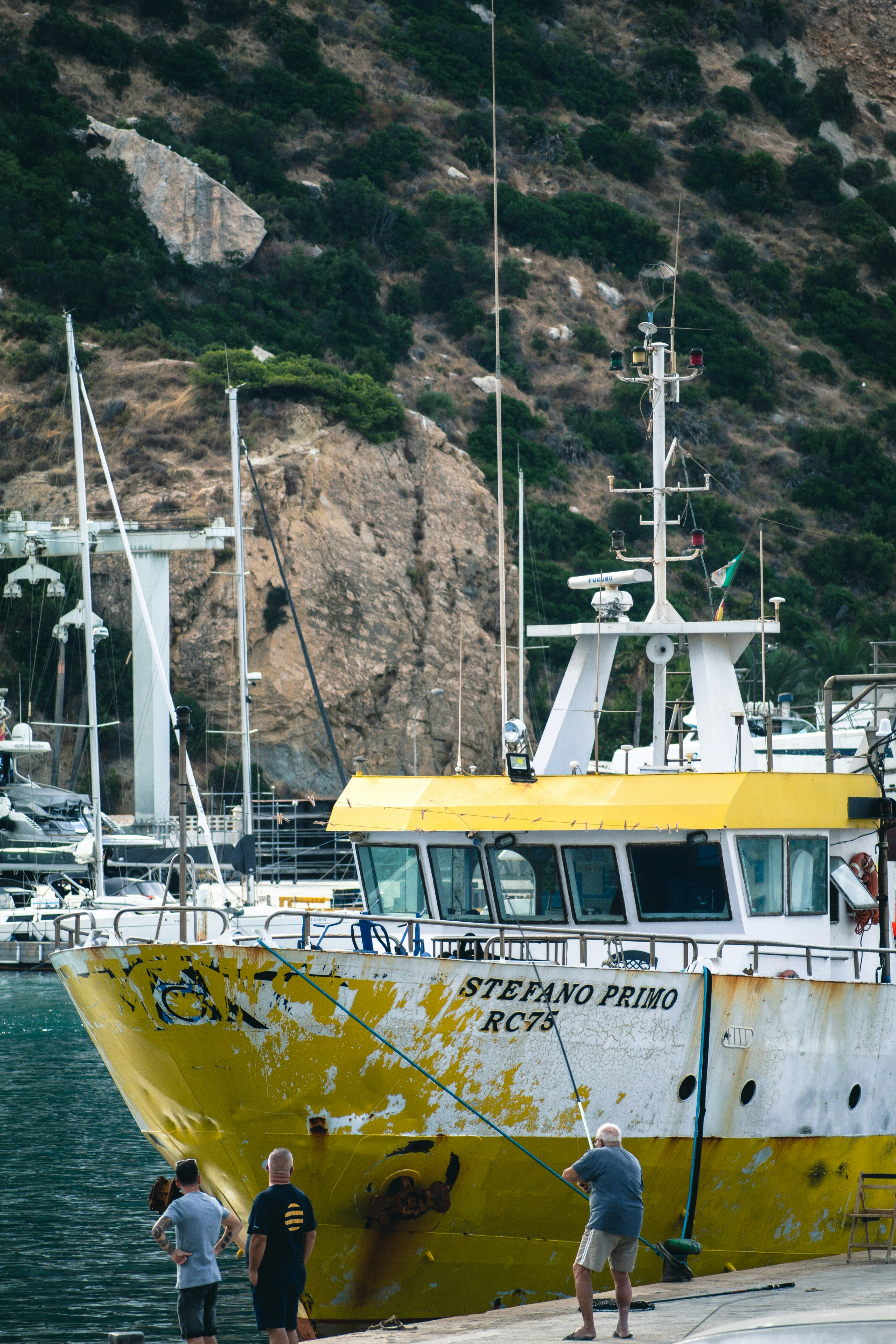 a group of people standing next to a boat on a body of water