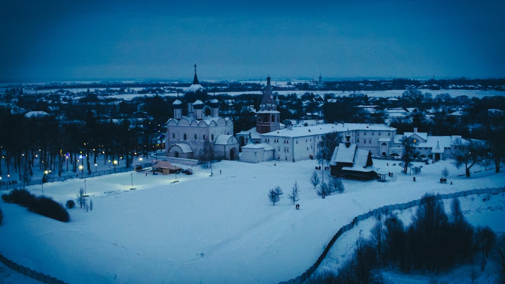 a large building with a tower in the snow