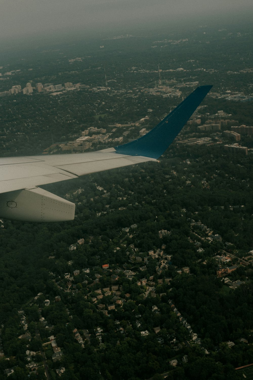 an airplane wing over a city