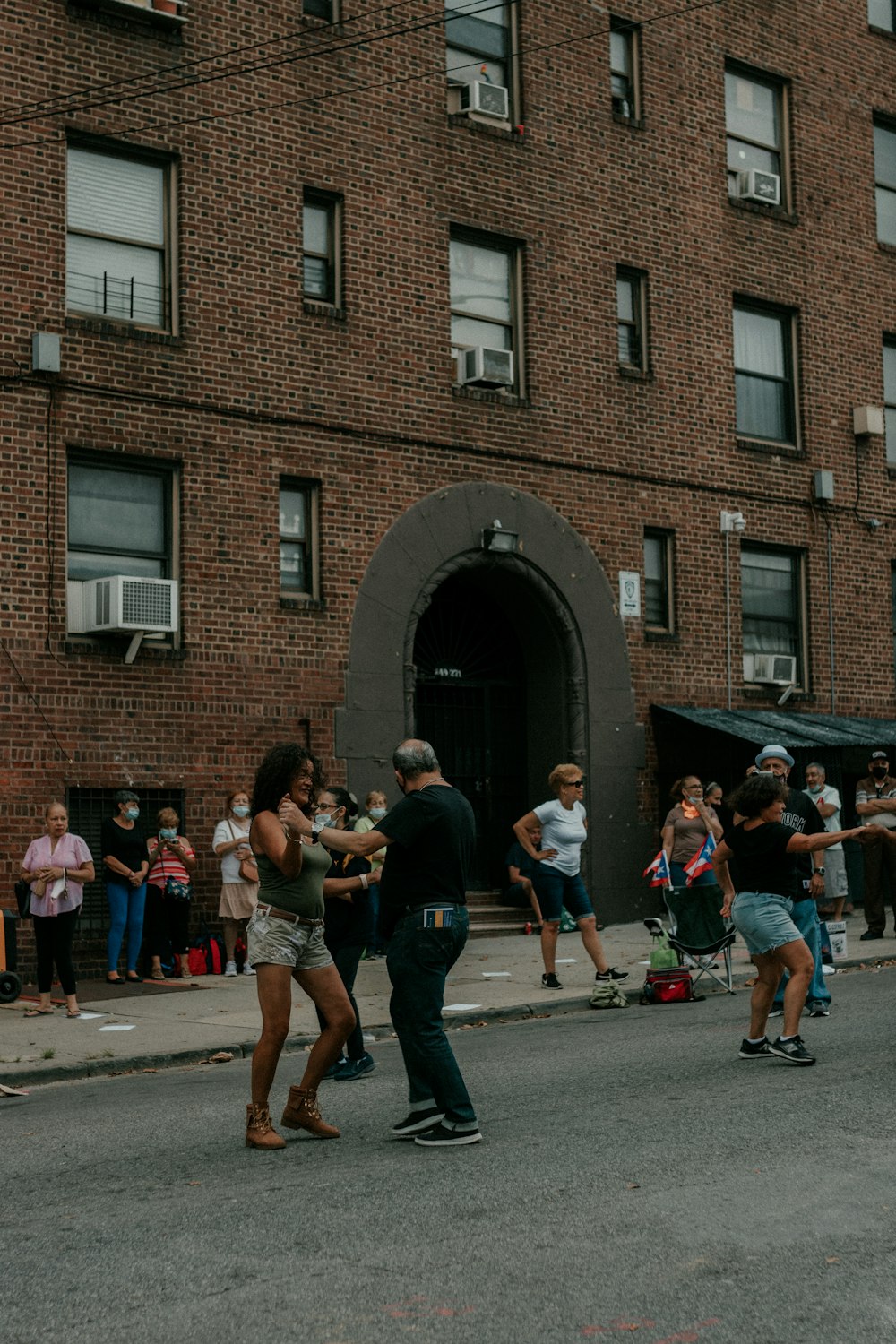 a group of people standing outside a brick building