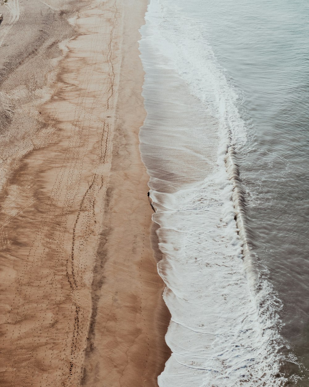 a sandy beach with waves crashing