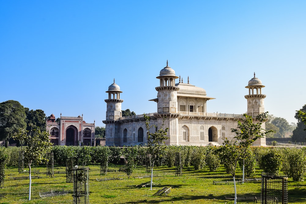 a large building with towers and a lawn in front of it