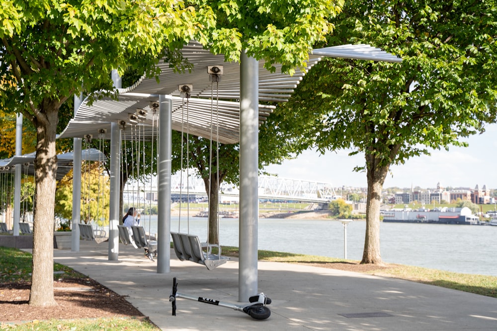 a person sitting on a bench under a covered area