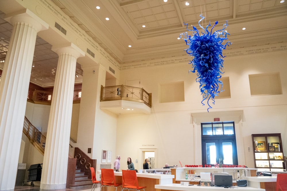 a room with a large chandelier and a table with chairs