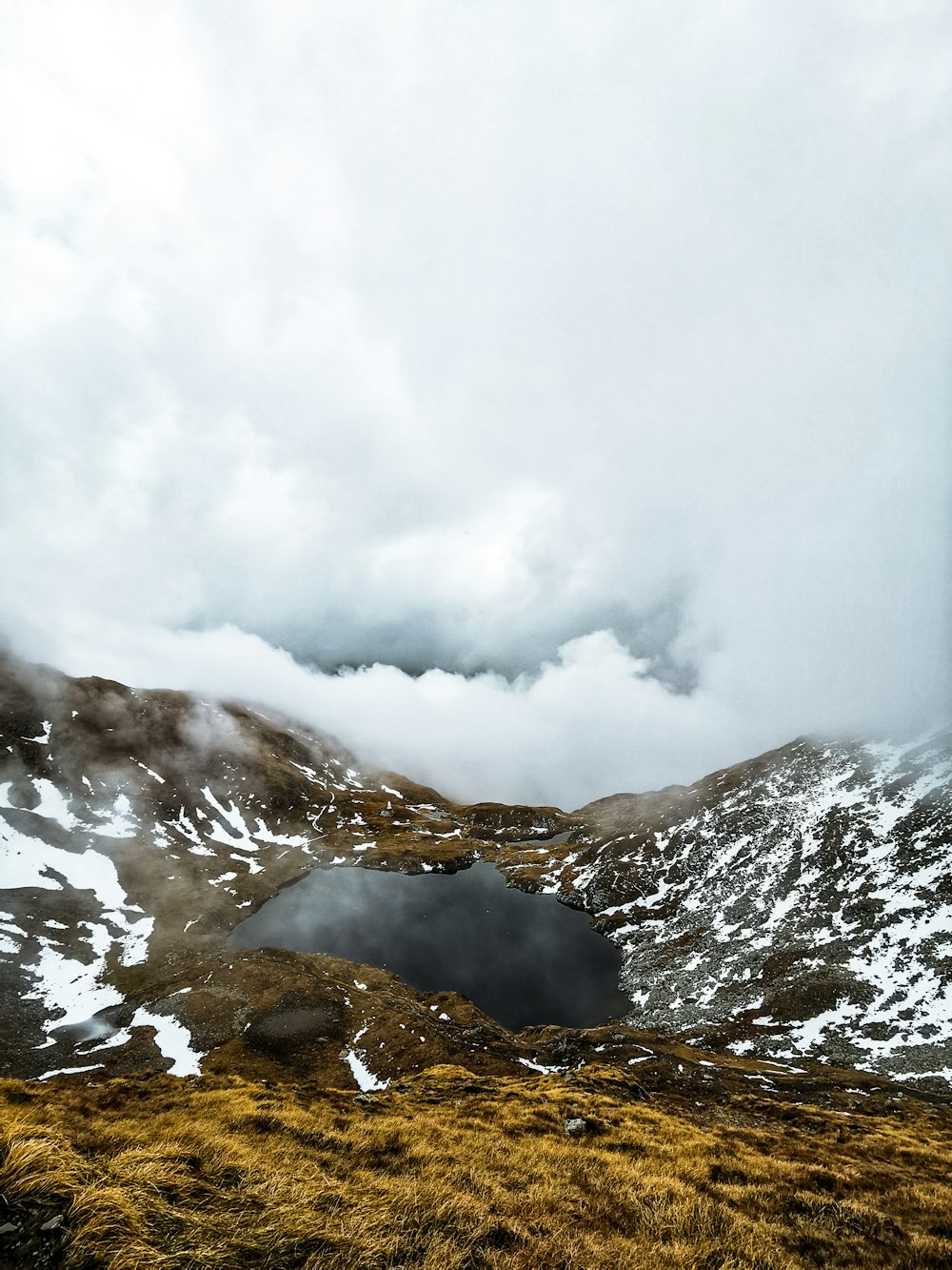 a snowy mountain with clouds