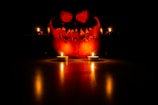 A spooky pumpkin display with eerie lighting.