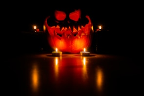 A spooky pumpkin display with eerie lighting.