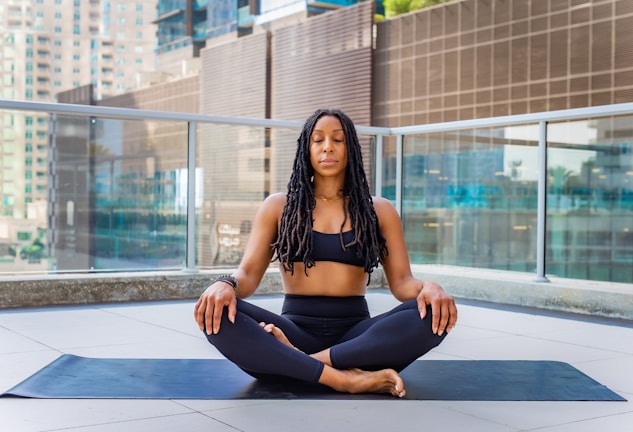 a woman sitting on a mat