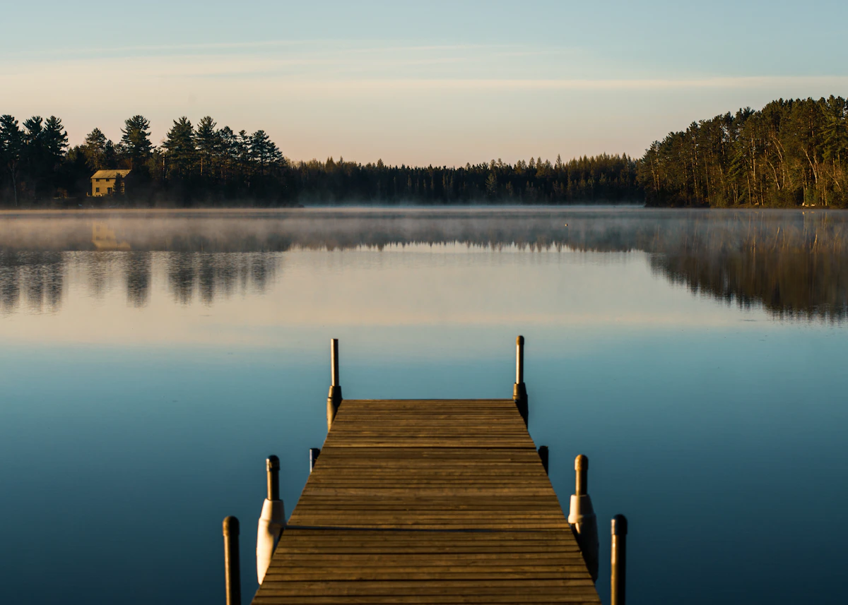 A quiet dock on a Wisconsin lake at sunset — the kind of view you get on the Merrimac Ferry crossing Lake Wisconsin