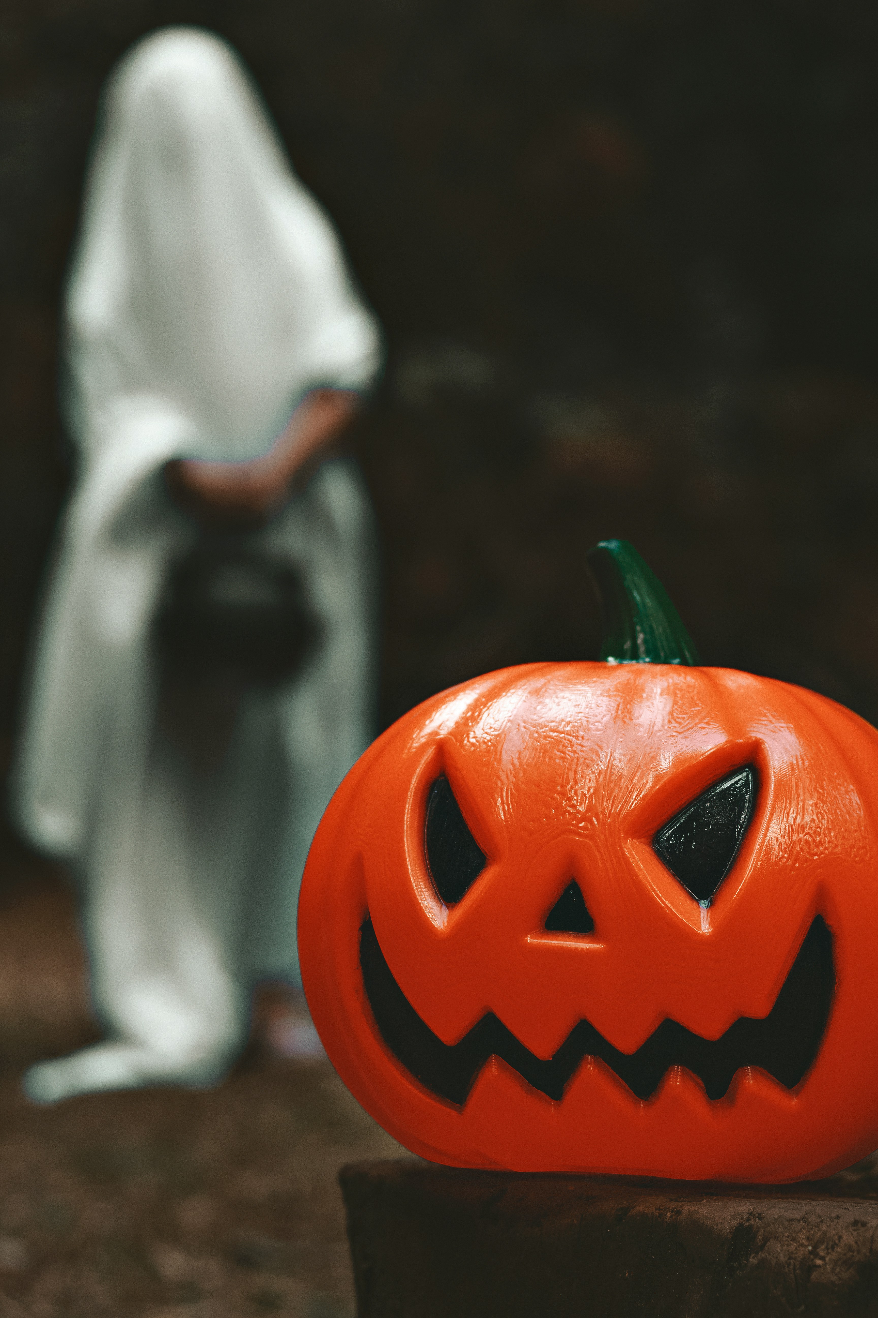 a carved pumpkin with a person in the background