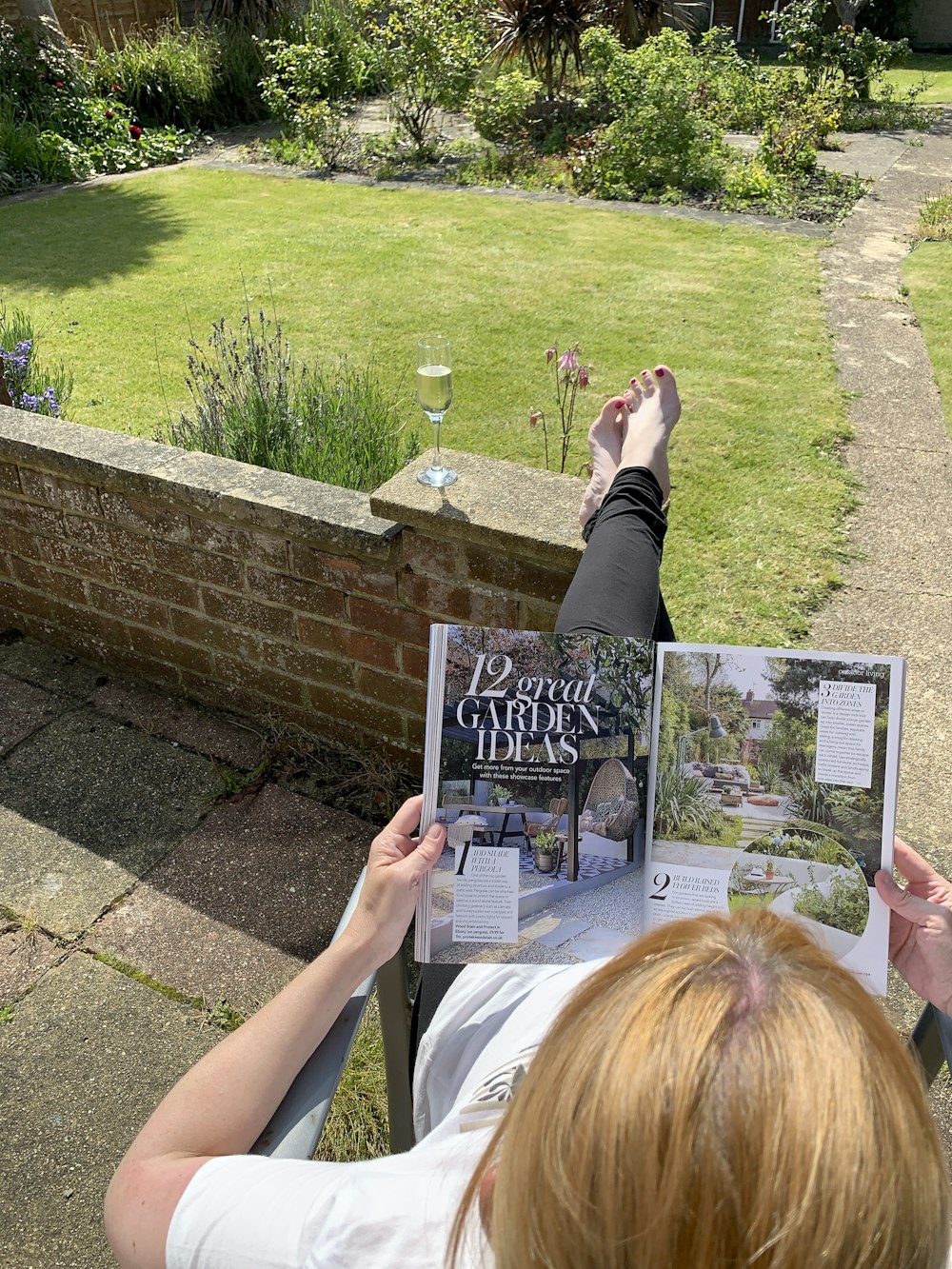 a person lying on the ground reading a book